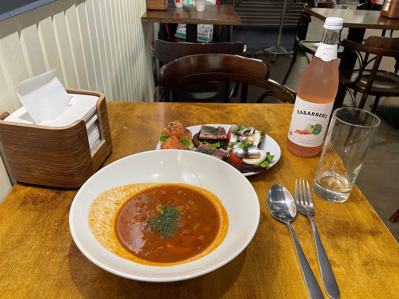 Soup with open rye-bread sandwiches of salmon and herring, and a rhubarb soda, at a Riga cafe