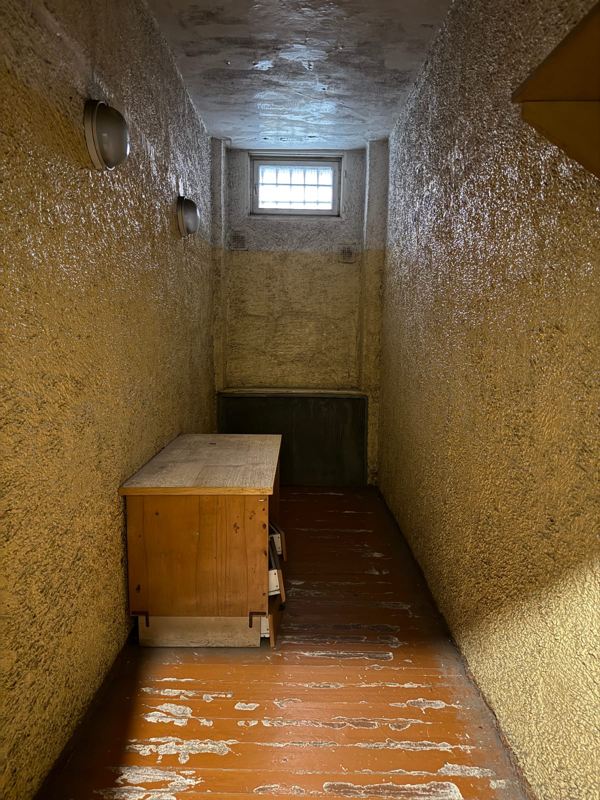 A bare cell in the Corner House, its walls deliberately roughened