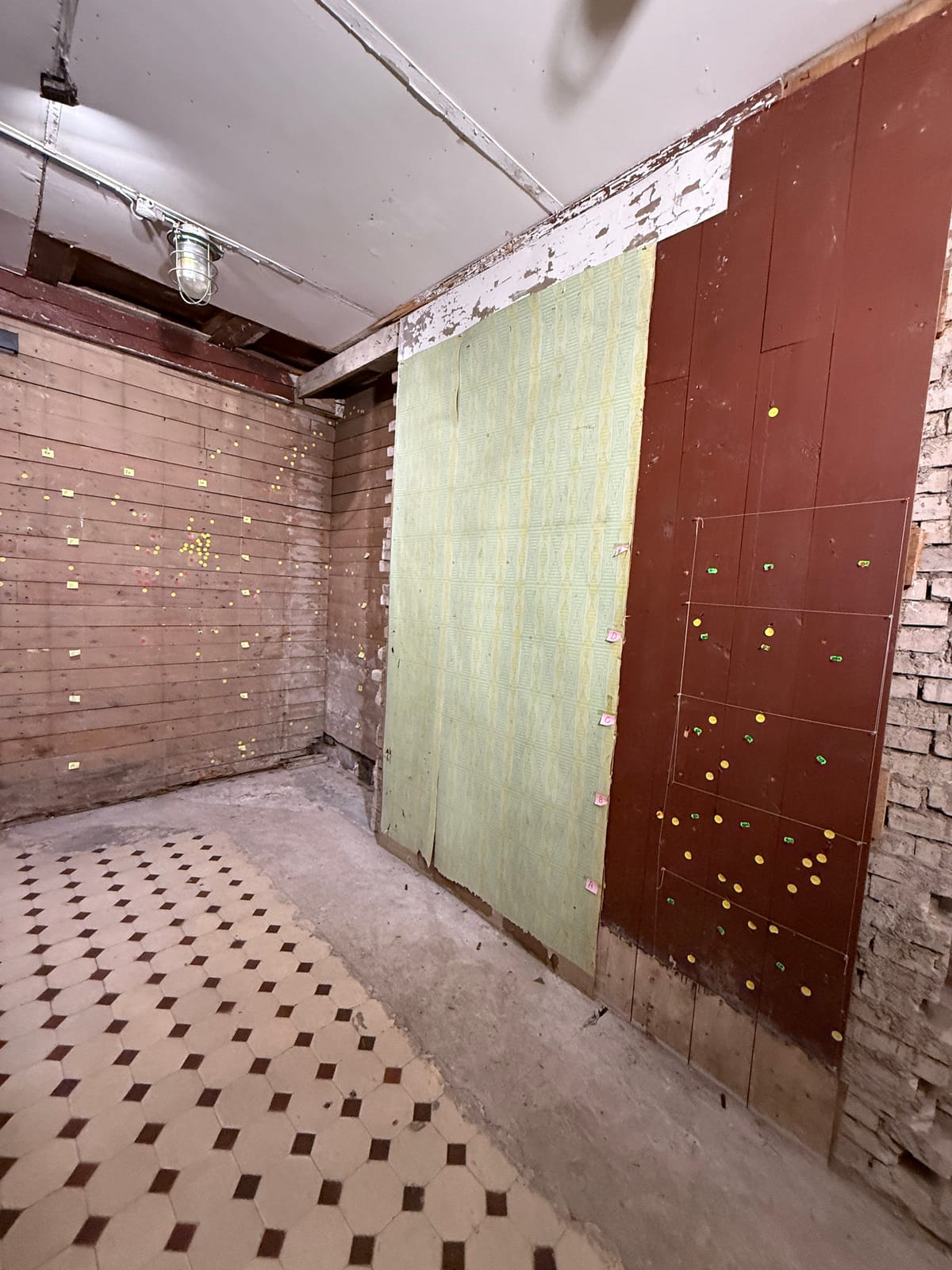 The execution room in the Corner House; the markers show the documented bullet holes in the panelling