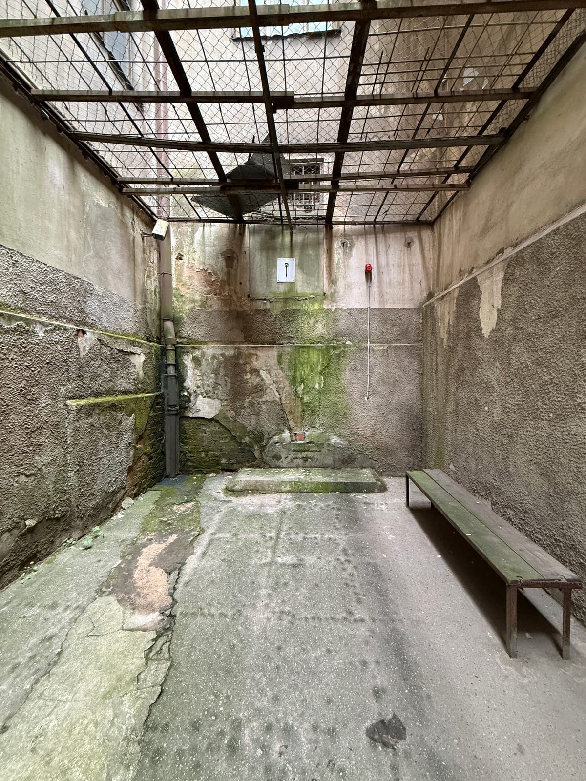 The Corner House exercise yard, caged over with iron grilles, the "tiger cage"