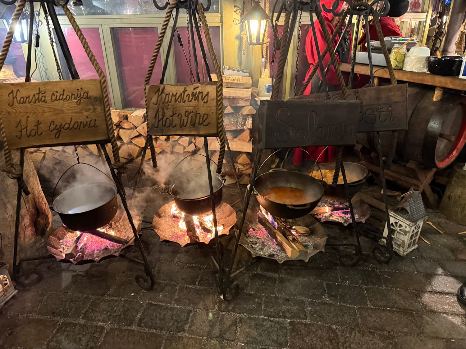 Cauldrons of mulled wine and hot quince punch over an open fire at the Riga Christmas market