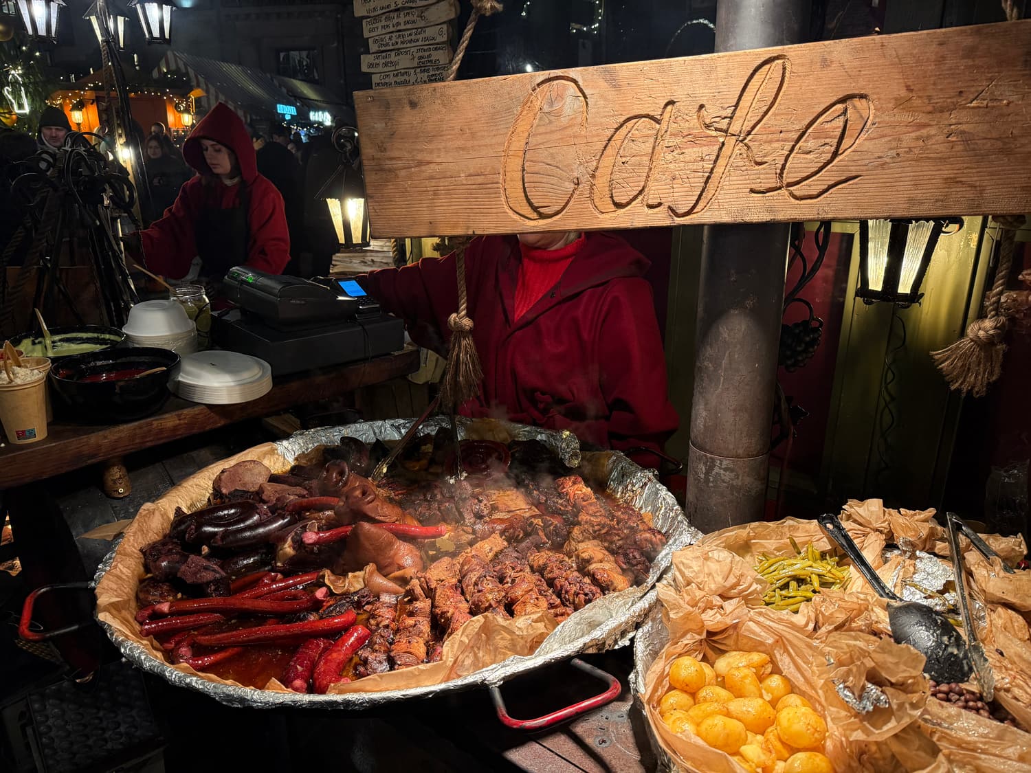 A stall of grilled meats, sausages and potatoes at the Riga Christmas market